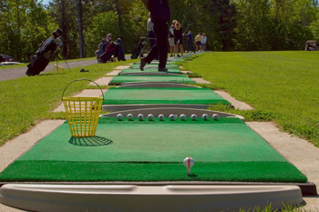 Guests trying out their skills on our premium driving range.